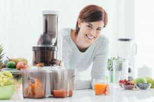 How do Juicers Work showing a woman and a juicer working