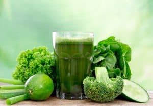 glass of green juice plus vegetables made by juicing in your home