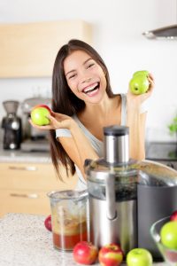 woman with juicer machine juicing for better health