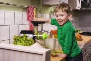 kid making green juice